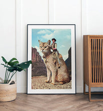 Cargar imagen en el visor de la galería, Cat Lone Ranger artwork featuring a cowboy riding a giant cat through a desert landscape, perfect for quirky and unique home decor, rodeo art and western desert interior design adds a playful touch to any room. Enhance your home decor with this imaginative and humorous print. Shop now for quirky wall art.