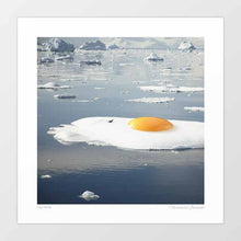 Cargar imagen en el visor de la galería, Surrealist artwork titled "Egg-berg" featuring a sunny-side-up egg on a melting iceberg. This piece by Vertigo Artography combines environmental themes with whimsical imagery, perfect for contemporary art collectors. Explore the fusion of reality and imagination with "Egg-berg," a striking addition to any modern art collection. Buy now to own a piece that sparks conversation and visual delight.