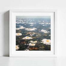 Cargar imagen en el visor de la galería, "Eggy Clouds" by Vertigo Artography - a surreal landscape art piece featuring clouds resembling fried eggs. Perfect for contemporary and whimsical art lovers. Unique nature inspired wall art with a touch of whimsy for sale.