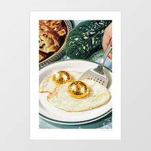 Load image into Gallery viewer, Surreal kitchen wall art print showing gold disco ball egg yolks on a fried egg – funny retro diner poster by Vertigo Artography